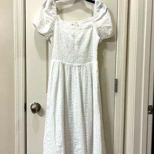 White mid length dress.
